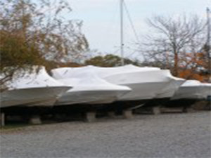 Covered boats parked on land